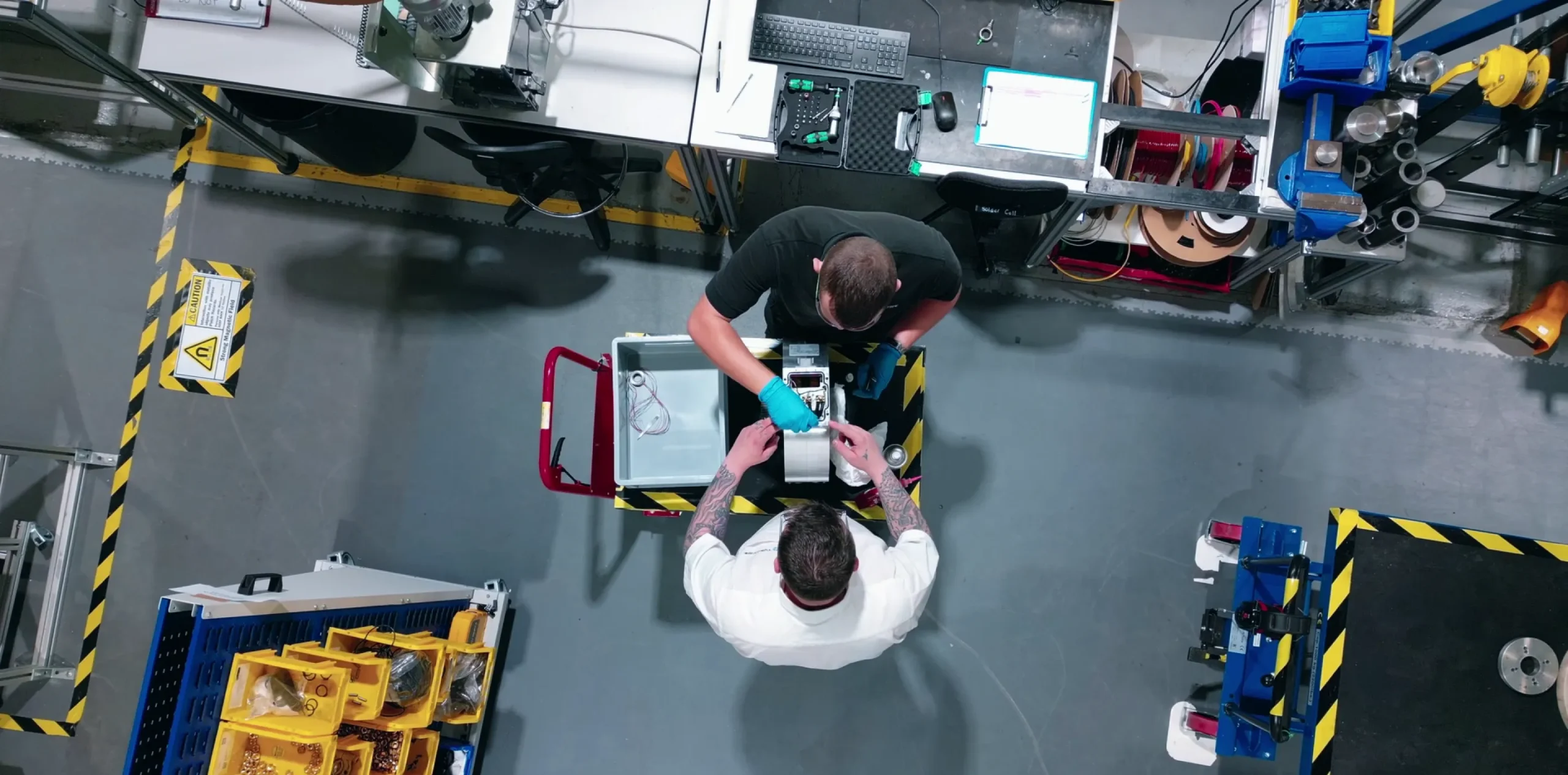 2 men putting together axial flux motor